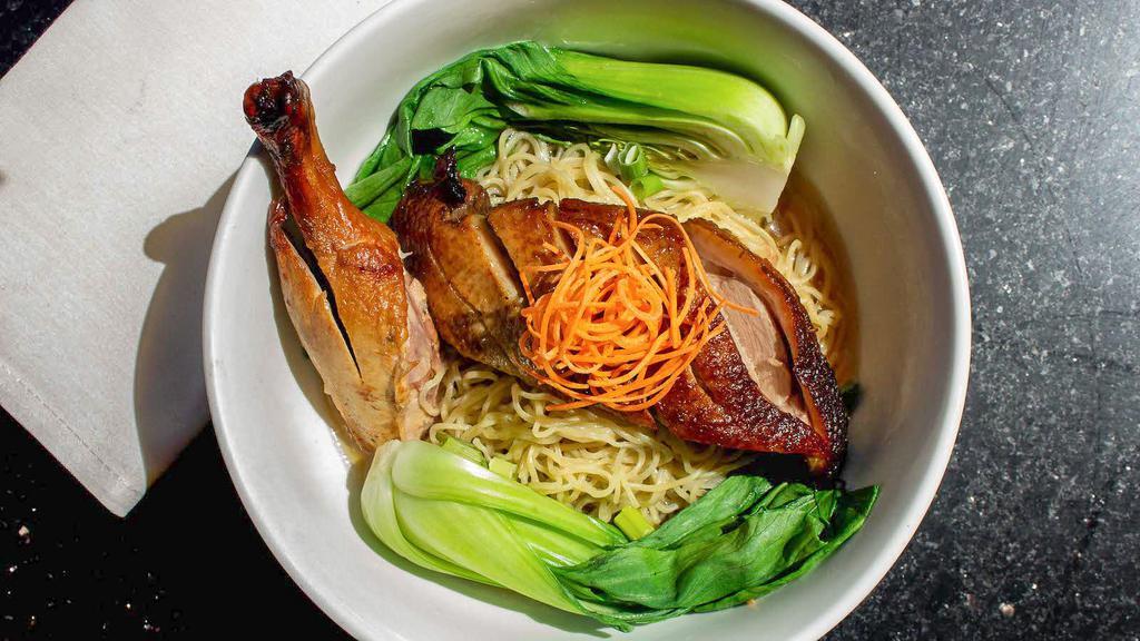 Duck Noodle Soup · Egg noodles with sliced roasted duck, baby bok choy, beansprouts, green onions, cilantro, and fried garlic.