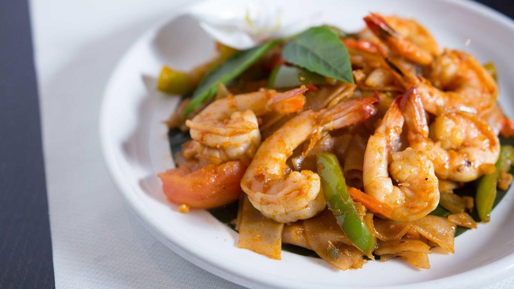 Drunken Noodles · Flat, fresh rice noodles stir-fried with bell peppers, tomatoes, onions, carrots, and fresh basil with spicy chili sauce.