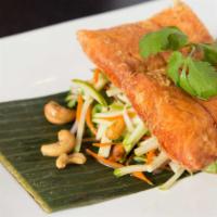 Sunset Salmon · Lightly seasoned salmon pan-fried to perfection then topped with tropical green apple salad,...