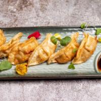 Potstickers · Fried wrapper are filled with chicken and cabbages served with house sauce.