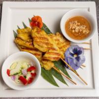 Satay Chicken · Grilled marinated chicken with herbs, served with warm peanut sauce and cucumber salad.