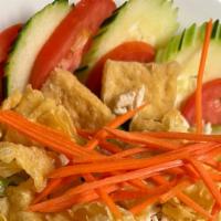 Thai Time Salad · A salad of lettuce, cucumber, tomatoes, carrot topped with crispy wonton, fried tofu and tha...