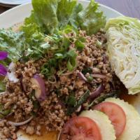 Larb · Minced chicken or pork tossed with spicy lime dressing red onions, dried chili and a touch o...