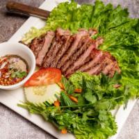 Tiger Cry Steak · Grilled steak served with authentic roasted rice powder thai spicy sauce.