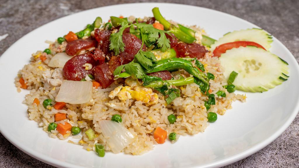 Chinese Sausage Fried Rice · Stir fried jasmine rice with Chinese sausage, egg, green and white onions, peas, carrots and Chinese broccoli in special sauce.