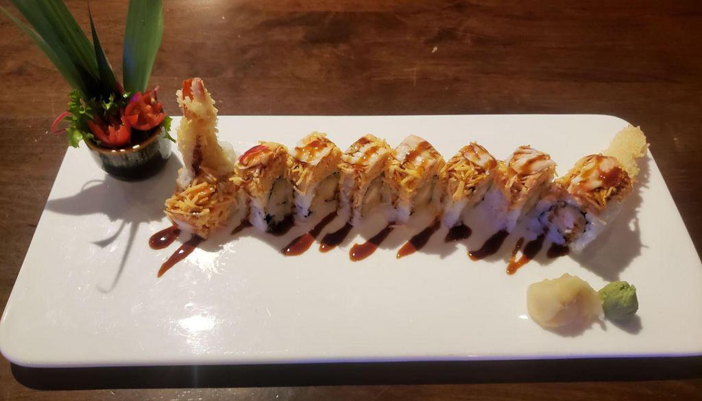 Volcano Roll · Inside roll:  Shrimp tempura, eel sauce. Outside roll: Spicy king crab and kani.