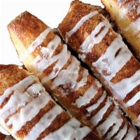 Cinnamon Sugar Breadsticks · Our signature dough covered in cinnamon and sugar baked to perfection and drizzled with icin...