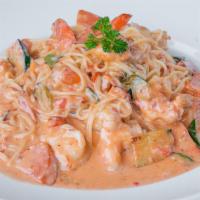 Angel Hair Pasta · Angel hair pasta in light cream sauce with shrimp garnished with fresh vegetables and Parmes...