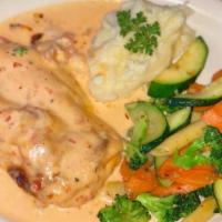 Chicken Bresat Cordon Bleau · Covered with slices of prosciutto and cheese topped with cream sauce