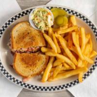 Reuben Sandwich · Corned beef or turkey with sauerkraut on grilled rye bread with lettuce and tomato, French f...