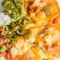 Nacho Platter Cheese · Crispy corn chips covered with refried beans, melted cheese, jalapeño peppers, guacamole, so...