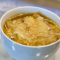 French Onion Soup · Slowly caramelized onions, splash of applejack brandy, rich chicken and beef broth, with her...