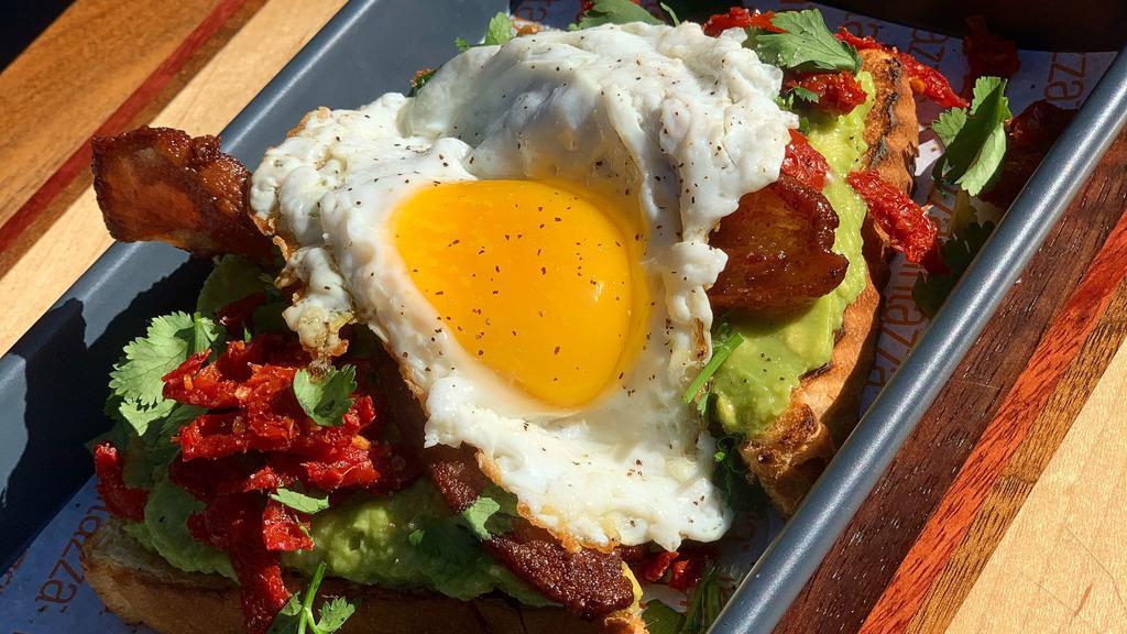 Original Avocado Toast · House-made avocado mash, brioche bread, sun dried tomatoes, cilantro, salt, and pepper. Try adding an egg or some other protein for a hearty meal!