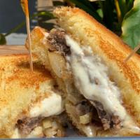 Ribeye Melt · Garlic aioli, creamy horseradish, tender ribeye, provolone cheese, grilled onions with a sid...