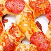 Pepperoni 'Za · A classic soft pretzel with a cheesy twist! Covered in smoked pepperoni and melted cheese, t...