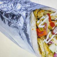 2- Chicken Shawarma Wrap · Chicken shawarma, pita bread, lettuce, cucumber, tomatoes, red onion, white sauce, and hot s...