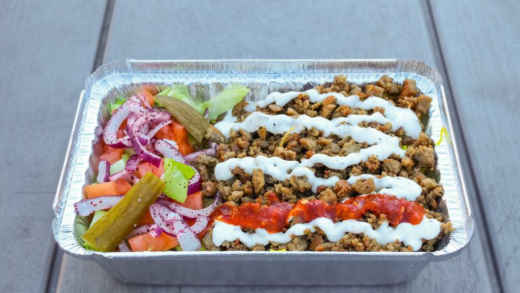 5- Gyro Plate · Gyro, rice, lettuce, cucumber, tomatoes, red onion, pickle, white sauce, and hot sauce.