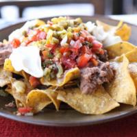 Nacho Ground Beef · The nachos come with cheese, beans, lettuce, pico de gallo, salsa, shredded cheese, sour cre...