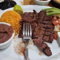 Plato Tipico · Steak served with homemade Queso Fresco, pico de gallo, Avocado, Rice, beans and fried corn ...