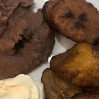 Bistec Encebollado · Grilled steak with sautéed onions. Served with rice, refried beans, mix salad greens with ho...
