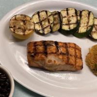 Salmon A La Campesina · Grilled salmon topped with creamy mushroom seafood sauce. Served with rice, black beans, and...