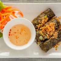 Beef In Grape Leaves · Marinated beef wrapped in our traditional grape leaves, topped with crushed peanuts and scal...