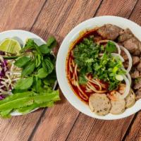 (Sp8) Bun Bo Hue / Spicy Beef Noodle · Spicy lemongrass, meatloaf, pork leg & beef broth with round rice noodle and slices of fresh...