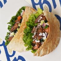 Beef And Lamb Gyro · Served on pita with tomato, onion and tzatziki sauce. Comes with a side salad or fries.