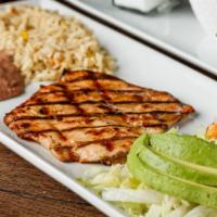 Pechuga A La Parilla · Tasty marinated grilled chicken breast. Served with lettuce, tomato, avocado, rice, refried ...