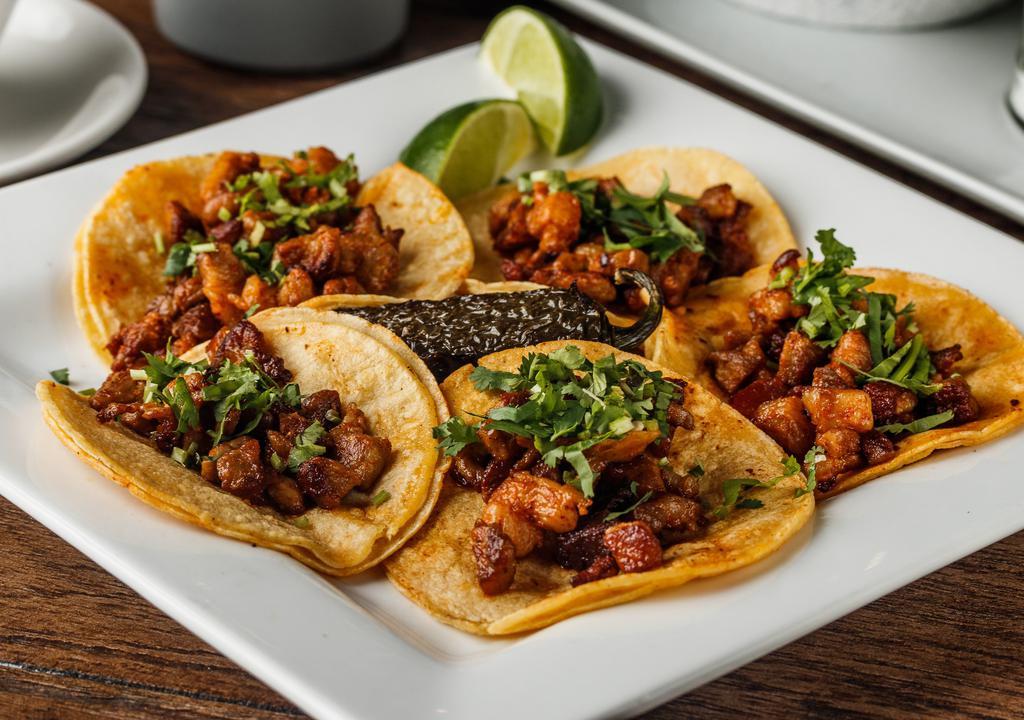 Street Tacos · Five mini corn tacos with your choice of meats (two meat max), a whole grilled jalapeño, cilantro, grilled onions, and a side of charro beans