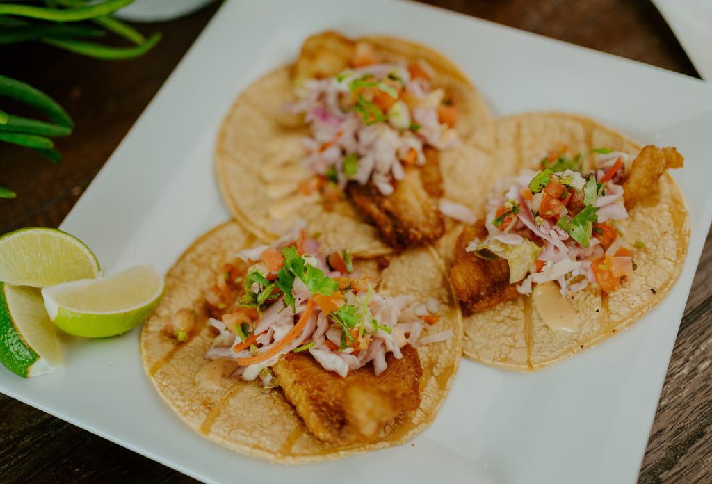 Baja Fish Tacos (3) · Fresh tilapia (grilled or fried) topped with shredded red cabbage, chipotle sauce, and pico de gallo. Served with rice and charro beans