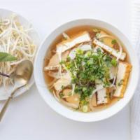 Blissful Pho · Traditional pho noodle soup with fresh rice noodle, fried tofu, soy ham served topped with b...