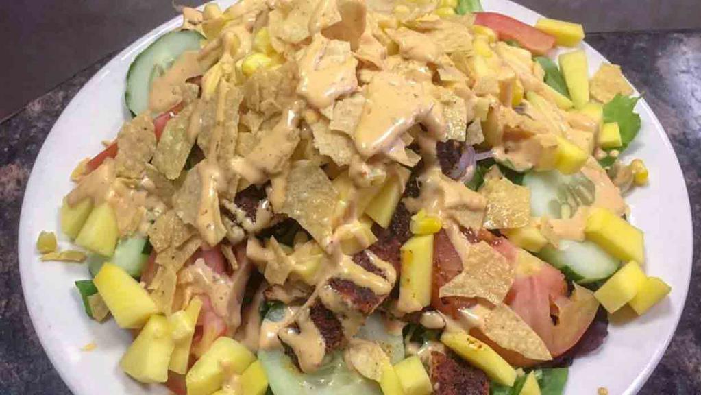 Mango Blackened Chicken Salad · Spring mix, tomatoes, cucumbers, red onions, corn, tortilla chips, mango strips and chipotle ranch. Served with bread.