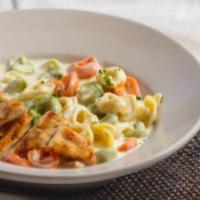 Tortellini · Tri-Color Tortellini Pasta Served with Shaved Ham and Our Home-made Alfredo Sauce.