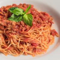 Spaghetti Bolognese · Home-made Meatsauce mixed in with our Spaghetti noodles and a hint of Marinara.