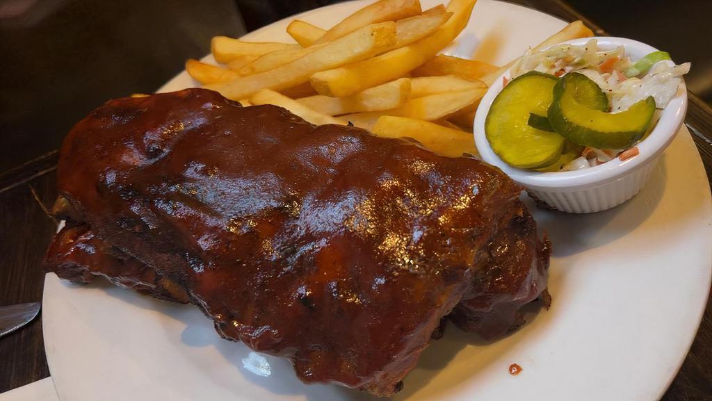 Full Rack Of Fall Of The Bone Ribs · Fries and coleslaw.