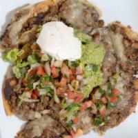 Nachos Supreme · Ground beef, beans, and monterrey cheese. Served with pico de gallo, guacamole, and sour cre...