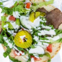 Gyro Wraps · lamb and beef thinly sliced and wapped in pita bread with pita  bread with lettuce , tomatoe...