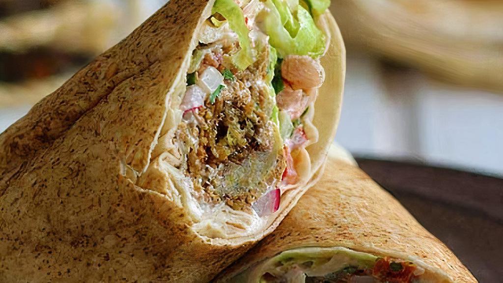 Falafal Wraps · deep fried veggies balls made fresh to order and wrapped in pita bread with tomato,cucumber,pickles, and feta chhese. served with signature white and red sauce.