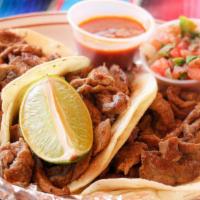 Tacos De Carne Asada Dinner · Three soft corn tortillas filled with rib eye. Served tomatillo sauce, pico de 
gallo and or...