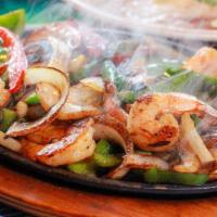 Fajitas De Camaron (16) · Served in a sizzling platter, grilled shrimp cooked w/ bell pepper, onions, served with bean...