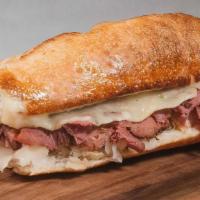 #7 Reuben · Thinly sliced Corned Beef, with our House Sauce, Sauerkraut and Swiss Cheese served toasted ...