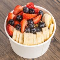 Acai Works · Acai topped with organic hemp granola sliced bananas strawberries blueberries and honey.