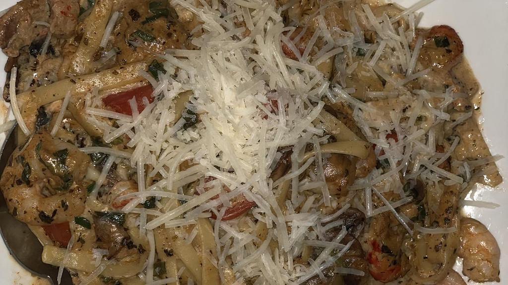 Pasta Orleans · Fettuccine sauteed with shrimp, crab meat, crawfish, mushrooms, tomatoes, and scallions in a pesto cream sauce with parmesan cheese.