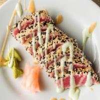 Sesame Crusted Tuna · Saku Ahi tuna, crusted in tuxedo sesame seeds, lightly seared, sliced and topped with cucumb...