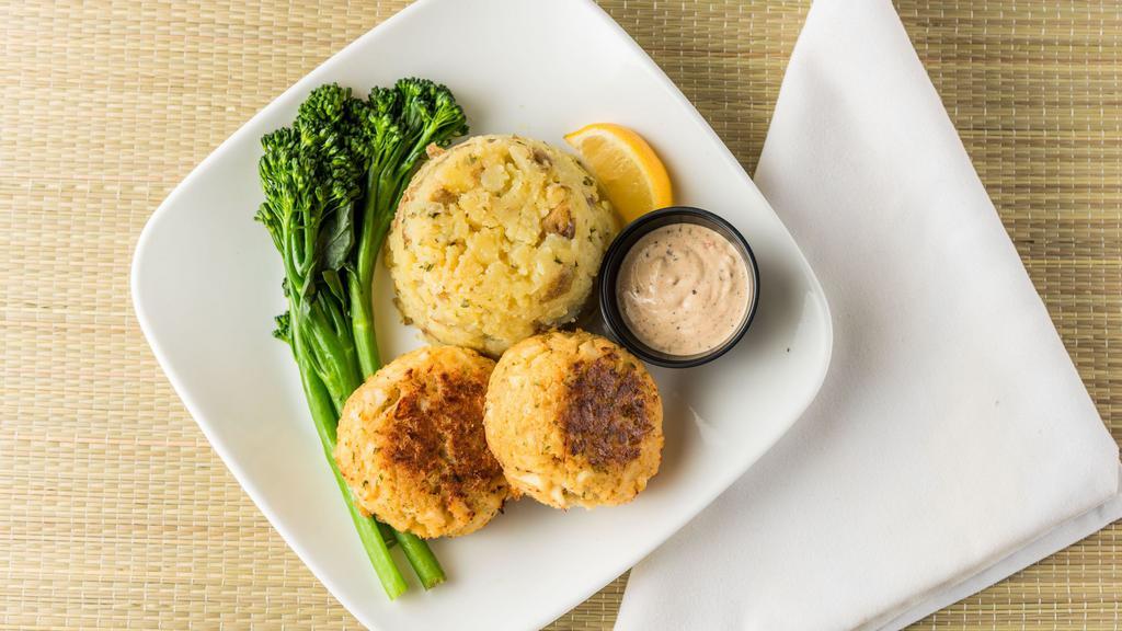 Crab Cakes · Two jumbo lump crab cakes, served with broccolini and roasted potatoes, with a side of remoulade sauce.