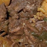 Res Guisada / Beef Stew · Servido con: Arroz y Habichuela o Moro o Yuca o Guineo o Tostones o Maduros / Served w/ Rice...
