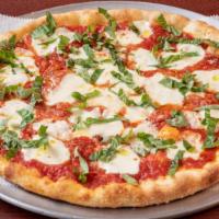Margherita Pizza · Crushed tomatoes, fresh mozzarella cheese, fresh basil and extra virgin olive oil.