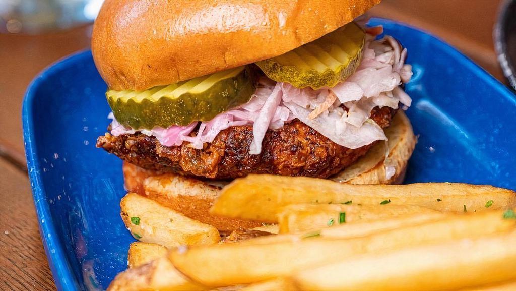 Nashville Hot Chicken Sandwich · breaded chicken breast, fried and tossed in original Nashville spicy sauce, topped wit coleslaw and pickles.  Served on a brioche bun.