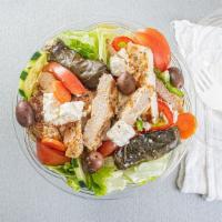 Greek Salad · Tomatoes, cucumbers, feta cheese, olives and grape leaves tossed over a bed of romaine lettu...